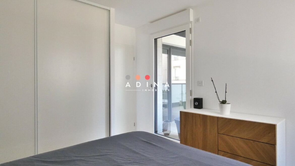 Chambre moderne avec lit et placard intégré.