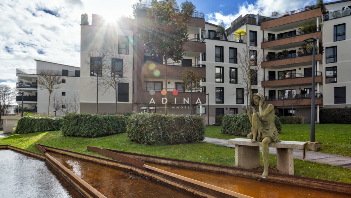 Immeuble moderne avec sculpture et bassin à Le Plessis-Robinson.